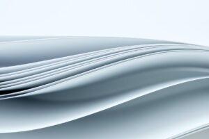 abstract background sheets of paper forming a pattern of curved lines